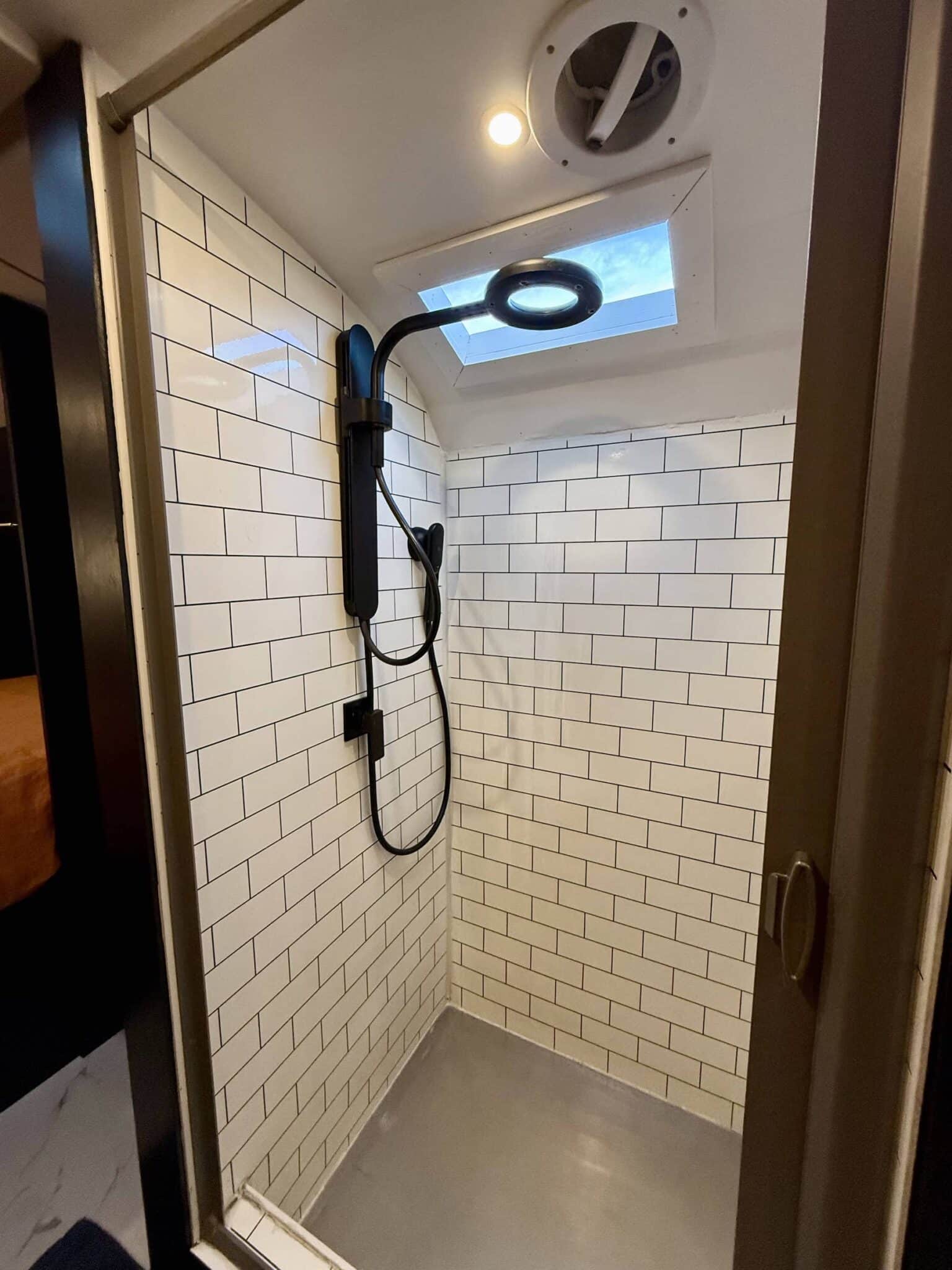 Shower stall inside a converted school bus