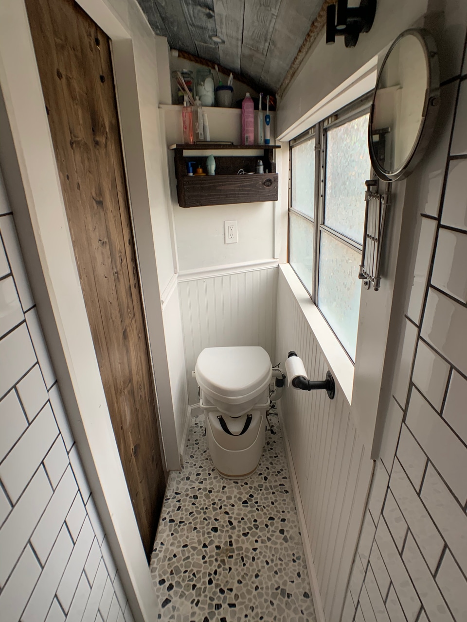 Composting toilet installed in a converted school bus bathroom