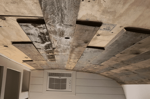 Would sheetrock really stay on the ceiling on a moving bus? Also the weight of the sheetrock.