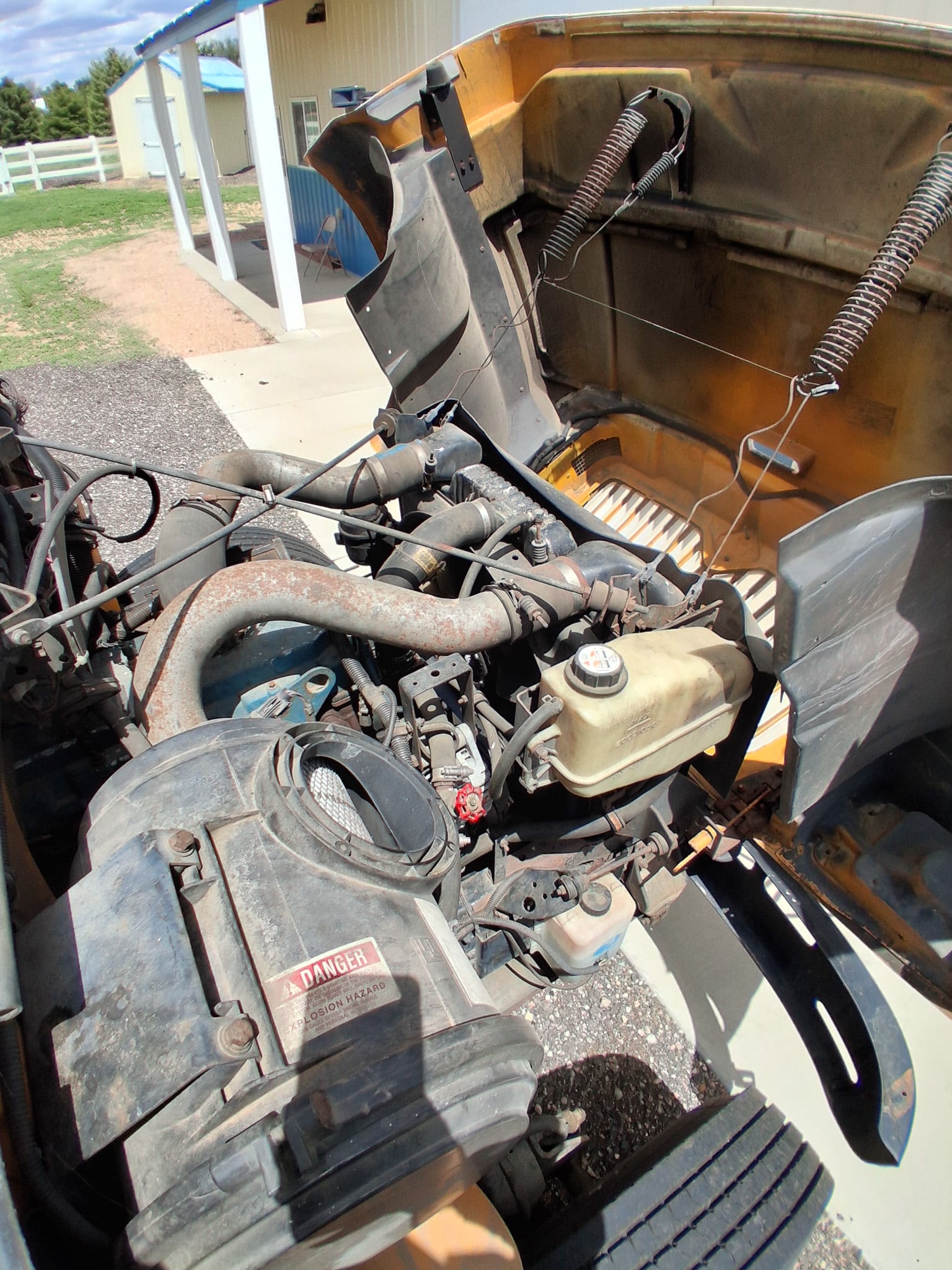 School bus diesel engine compartment with hood open for inspection