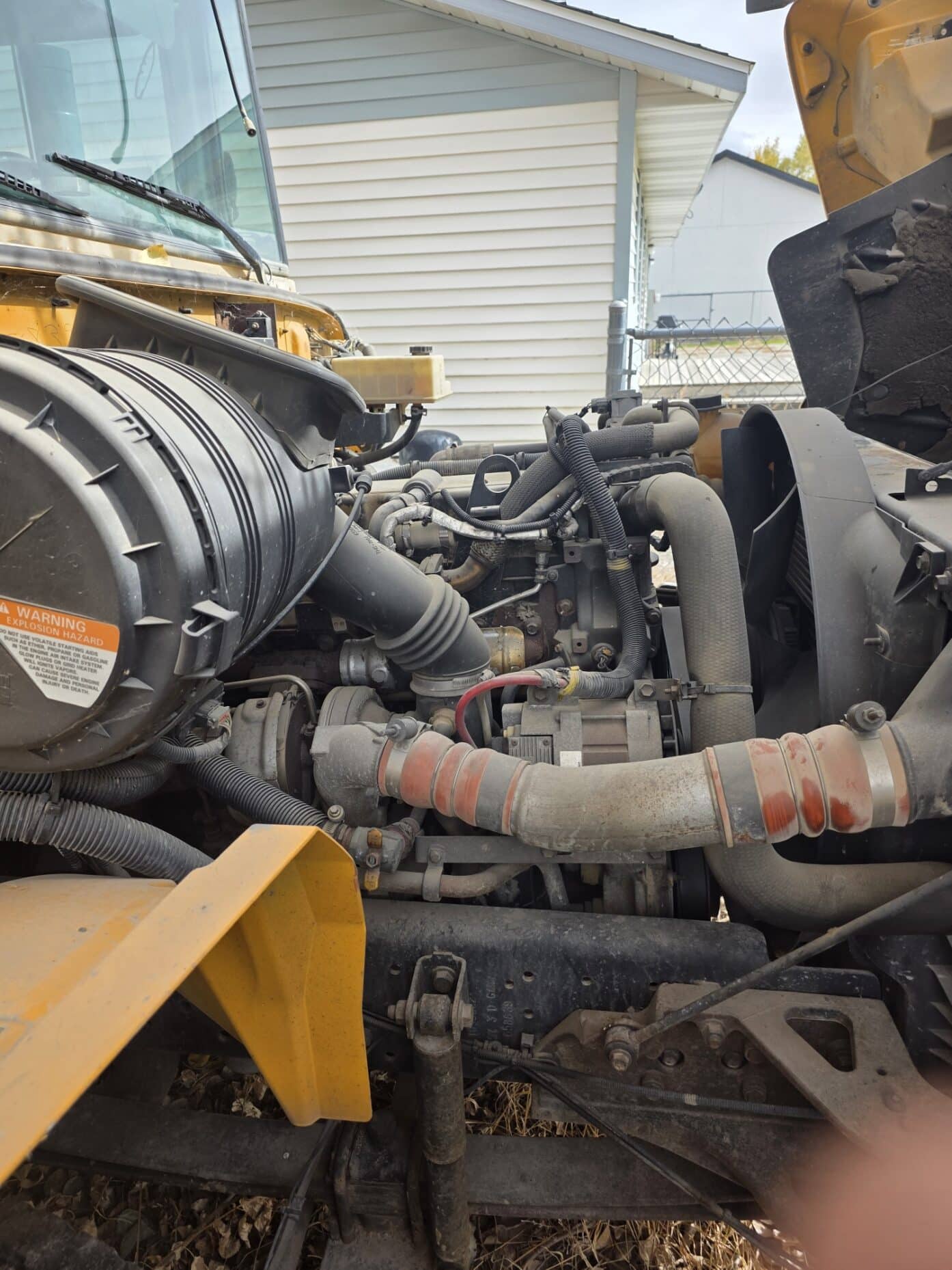 School bus diesel engine with hood open being worked on